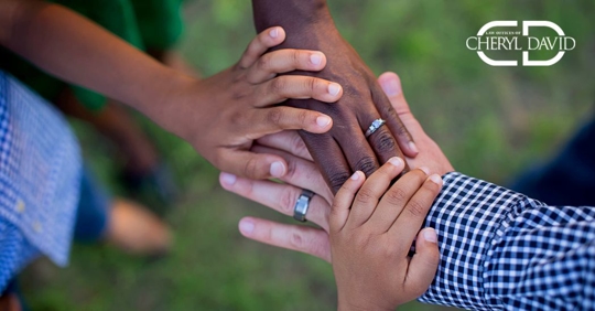 close up of a blended family holding hands